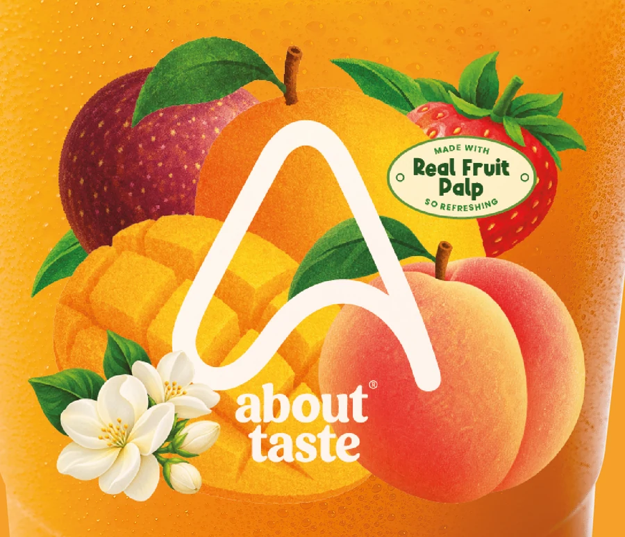 Close-up of the About Taste cup sticker: the A mark, the fruit illustration and the Real Fruit Pulp badge